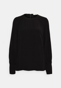 Černá blůza s dlouhými rukávy a kulatým výstřihem. Hladká textura s dekorativními knoflíky podél ramenních švů. Zapínání na zip vzadu.