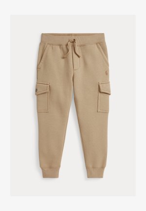 Beige brīvā laika bikses izgatavotas no kokvilnas maisījuma, ar divām sānu kabatām un kravas stila kabatām ar spiedpogu aizdari. Elastīga jostele ar auklu.