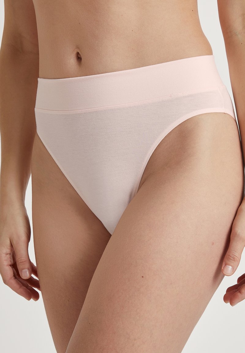 Svetloružové bikiny s vysokým pásom vyrobené z mäkkej a elastickej látky. Vlastnosti zahŕňajú hladký pás a bezšvové strany.