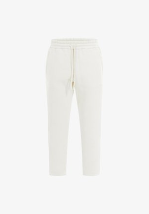 White, slim-fit joggers made of soft fabric, featuring an elastic waistband, drawstring, and side pockets. Simple design without patterns.