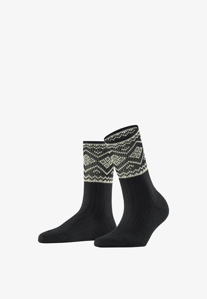 Schwarze Socken mit einem gemusterten, gestrickten Bündchen in Creme und Schwarz. Das Design zeigt geometrische Formen und eine gerippte Textur am Schaft.