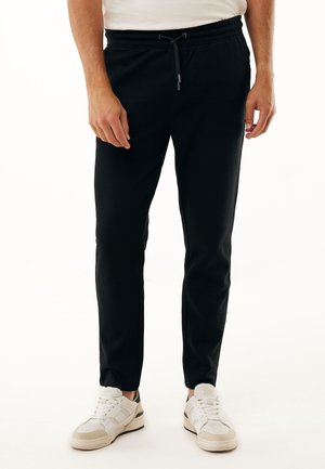 TAPERED FIT - Tracksuit bottoms - black