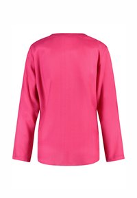Long-sleeve shirt in bright pink, smooth fabric, round neckline, subtle sheen, and a straight cut design. Back view shown.