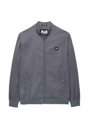 Hallidega hall pommjakker, millel on lukuga ees, seisukrae ja kaks küljetaskut. Rinnal on väike must logopatch. Sile kangastekstuuri.