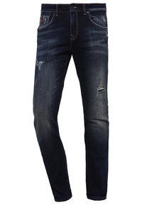 Jeans slim bleu foncé avec zones délavées et détails usés aux cuisses et aux genoux, avec poches avant et passants de ceinture.