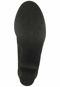 Suola di scarpa in gomma nera con motivo a raggi di sole e logo impresso "FLY LONDON". Superficie leggermente testurizzata, forma curva nel tallone.