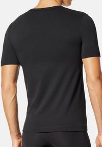 Black short-sleeve t-shirt made of smooth cotton fabric. Simple crew neck design with no visible logos or patterns on the back.