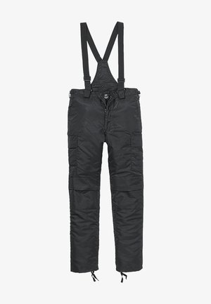 Schwarze isolierte Latzhose aus Nylon, ausgestattet mit verstellbaren Trägern, mehreren Taschen und elastischen Bündchen an den Knöcheln.