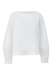 Blouse blanche à manches longues avec une coupe ample, un col rond et des poignets boutonnés, présentée sur un fond uni.