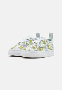 Light blue canvas sneakers with a playful green cartoon character print, white rubber sole, and lace-up design. Features a convenient pull tab.