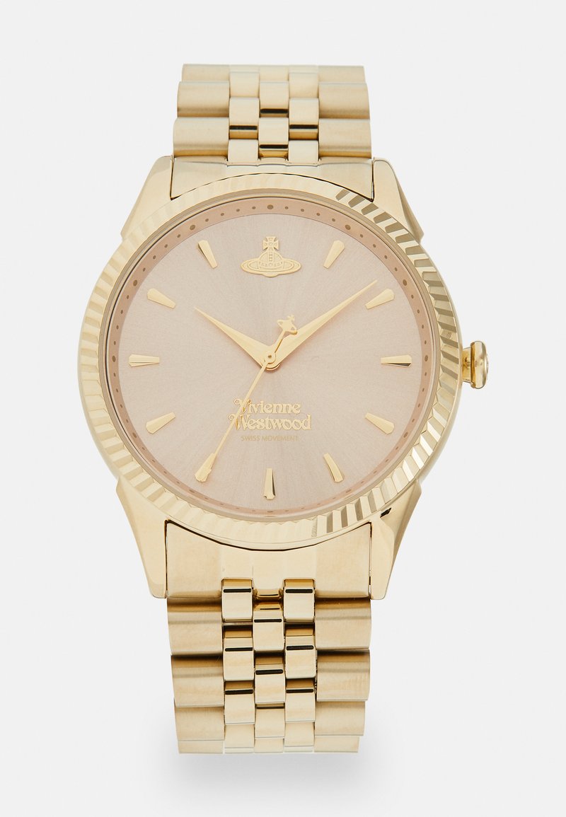 Ρολόι χρυσής απόχρωσης με υφή, ανοιχτόχρυσου καντράν, δείκτες και δείκτες ωρών. Διαθέτει χοντρή μεταλλική μπάντα και ραβδωτή στεφάνη.