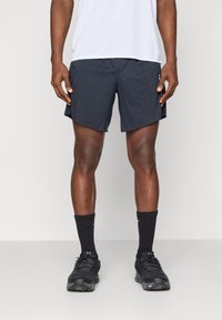 Men's dark navy athletic shorts with a relaxed fit, made of lightweight material. Features side pockets and minimal branding. Black socks and shoes.