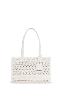 White perforated tote bag with triangular cut-outs, smooth texture, dual handles, and a detachable tag featuring the brand name in black.