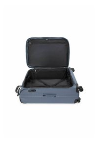 Valise souple bleue avec une fermeture éclair ouverte, doublure intérieure noire, poche en mesh et sangles croisées pour sécuriser le contenu.