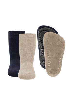 Dwie pary niewidocznych, antypoślizgowych skarpet, jedna czarna i jedna beżowa, przedstawione z przodu i od strony wewnętrznej podeszwy na białym tle.