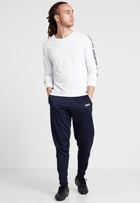 JAKO ACTIVE - Trainingsbroek - navy/white