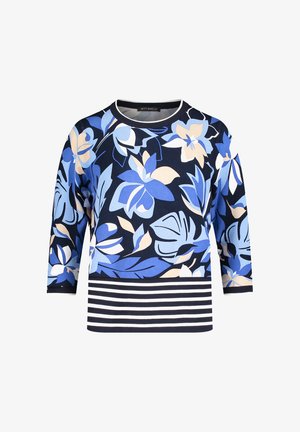 Damestrui in marineblauw met grote lichtblauwe en beige bloemenprint en witte en marineblauwe horizontale strepen aan zoom en manchetten.