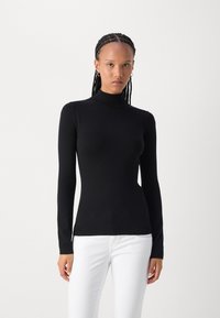 Black long-sleeve turtleneck sweater made of a smooth, stretchy fabric, featuring a fitted silhouette and ribbed edge at the hem.