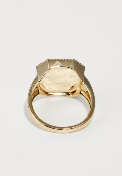 Gold ring with a hexagonal top, smooth texture, and subtle ridged detailing. The interior is polished, showcasing a shiny finish.
