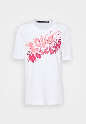 Valkoinen puuvillainen T-paita, jossa on vaaleanpunainen graafinen kuvio, joka muodostaa sanat "LOVE MOSCHINO" roiskevaikutelmalla. Lyhyet hihat, pyöreä kaula-aukko.