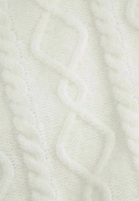 Biały sweter z dzianiny, posiadający teksturowany wzór w warkocze z diamentowymi kształtami. Miękki, puszysty materiał z wypukłymi skręconymi detalami.