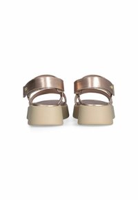 Metallic rose gold sandals with a wide adjustable strap, beige chunky sole, and open back design. Smooth texture with minimal hardware detail.