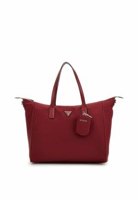 Sac fourre-tout rouge en matériau synthétique lisse. Dispose de doubles poignées, d'un logo triangulaire et d'une petite étiquette rectangulaire. Fermeture zippée.