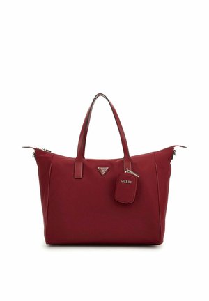 Sac fourre-tout rouge en matériau synthétique lisse. Dispose de doubles poignées, d'un logo triangulaire et d'une petite étiquette rectangulaire. Fermeture zippée.