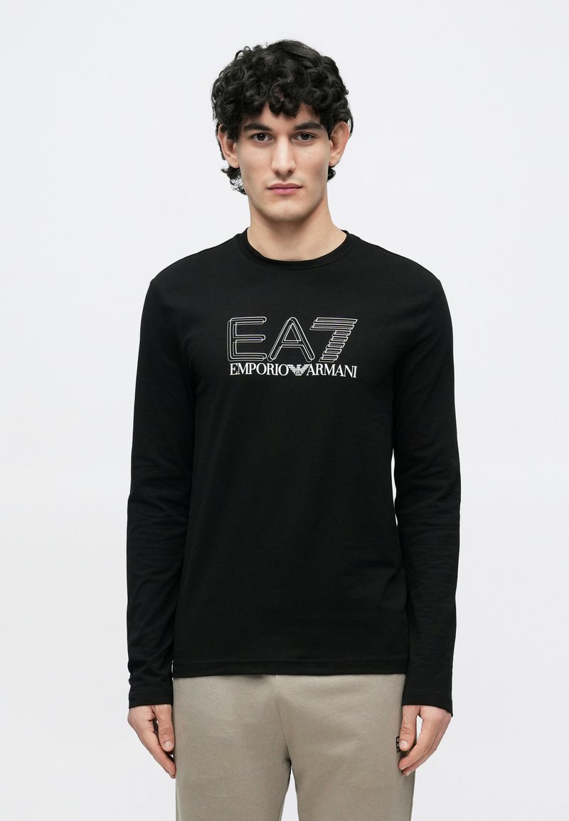 Must pikkade varrukatega T-särk pehmest kangast, ümar kaelus. Esiküljel valge graafiline logo "EA7 EMPORIO ARMANI".