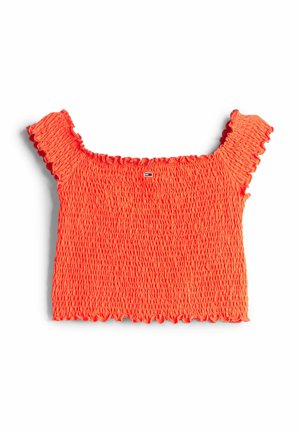 Top court smocké en orange vif avec des manches courtes et volantées. Présente une surface texturée et un ourlet festonné. Détail de petit logo au centre.