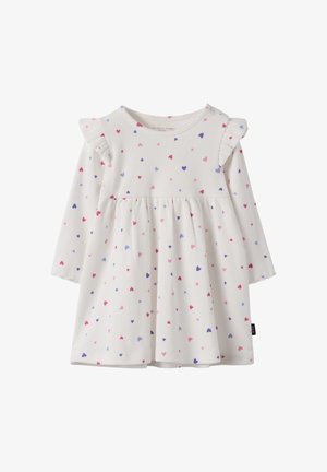 Lange mouw jurk van witte geribbelde stof met een gathering in de taille. Kenmerkt kleurrijke hartpatronen in roze en paars, en ruches op de schouders.