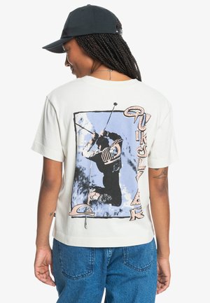 Cream short-sleeve t-shirt with a graphic print on the back. The design features a silhouette in action against a blue background.