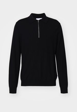 Pull noir à manches longues avec un col zippé, fabriqué en tissu tricoté. Il présente une coupe ajustée et des poignets et un ourlet côtelés.