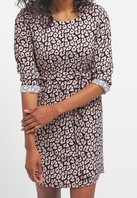 Black dress with pink floral pattern, three-quarter sleeves with light blue cuffs, cinched waist, and smooth fabric texture.