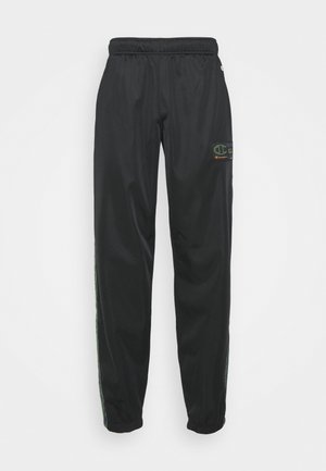 Schwarze Champion-Jogginghose mit elastischem Bund und Bündchen, ausgestattet mit einem kleinen Logo-Patch am rechten Oberschenkel und seitlichen Streifen.