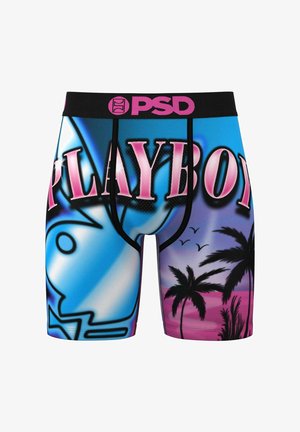 Ropa interior estilo trunks con una cinturilla negra que presenta el logo 'PSD'. Diseño vibrante en azul y rosa con palmeras y texto estilizado.