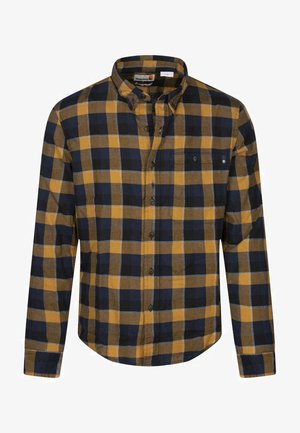 Chemise en flanelle à carreaux bleu marine, jaune et marron. Design à boutons avec un col et une poche poitrine unique. Texture douce avec une coupe régulière.