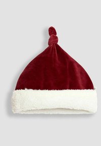 Cappello di Babbo Natale in velluto rosso con un bordo in pelliccia sintetica bianca e una punta annodata sulla sommità. Morbido al tatto; forma conica.