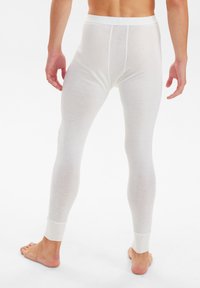 Hvide thermolegins lavet af et blødt, letvægtsstof. De har en tætsiddende pasform med en simpel ribbet talje og ankelmanchetter.