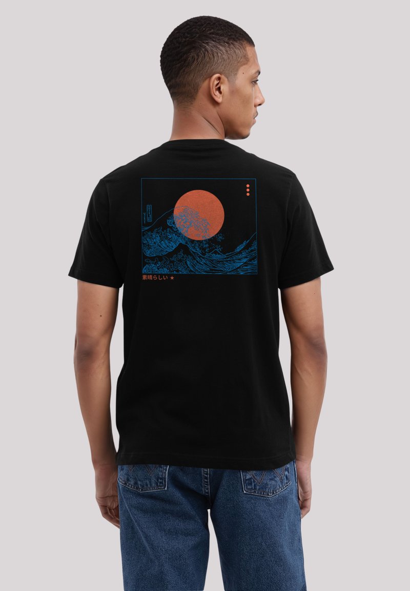 Black cotton t-shirt featuring a blue graphic of waves and a large red sun on the back, with Japanese text and a rectangular border.