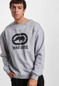 Gray cotton sweatshirt featuring a large black graphic of a rhino and the text "*eckō unltd." on the front. Relaxed fit with ribbed cuffs.
