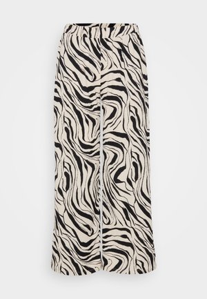 Spodnie szerokie z lekkiego materiału, z czarno-białym nadrukiem w zebrę. Elastyczny pasek w talii oraz gładka tekstura.