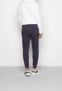 Nike Sportswear Träningsbyxor - dark purple