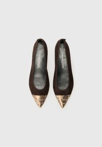 Ballerines pointues en suede marron avec un bout en cuir texturé doré et noir à motif animal, présentant une semelle intérieure en cuir lisse et un design minimaliste.