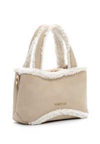Beige suede handbag with fluffy white trim and dual top handles. Features a gold logo accent on the side and a structured shape.