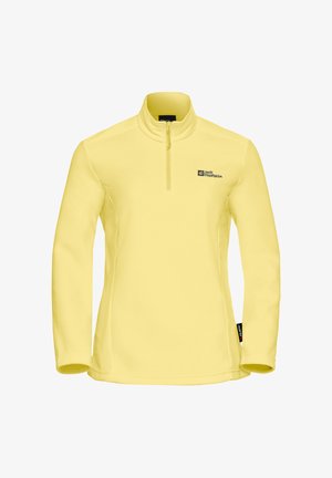 Pull en polaire jaune avec un col haut et une fermeture éclair quart, comportant un petit logo noir en haut à gauche et une étiquette sur le côté.