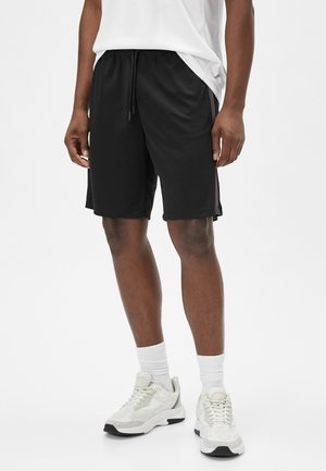 Sorte athletic shorts med elastisk talje og snøre. Fremstillet af letvægtsmateriale, med sidelommer og en afslappet pasform.