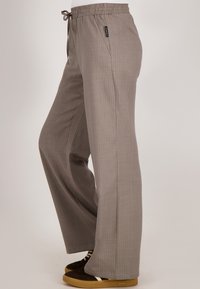 Lichtbruine, wijde broek met verticale strepen, elastische tailleband met trekkoord, zijzakken en een gladde stoftextuur.