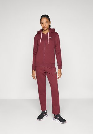 Maroon hoodie with pink drawstrings, zip closure, and logo. Matching maroon sweatpants with logo, worn with black athletic shoes.
