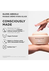 Hand die een pot Kérastase Gloss Absolu-crème vasthoudt; tekst benadrukt veganistische, sulfaatvrije formule, geen dierproeven en 100% productie met hernieuwbare energie.